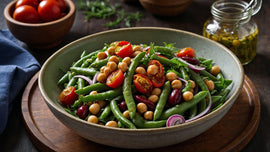 A bowl of vibrant South African 3-bean salad, featuring green beans, chickpeas, kidney beans, cherry tomatoes, and red onion, beautifully garnished with fresh greens and served with a jar of tangy dressing, perfect for traditional braais.